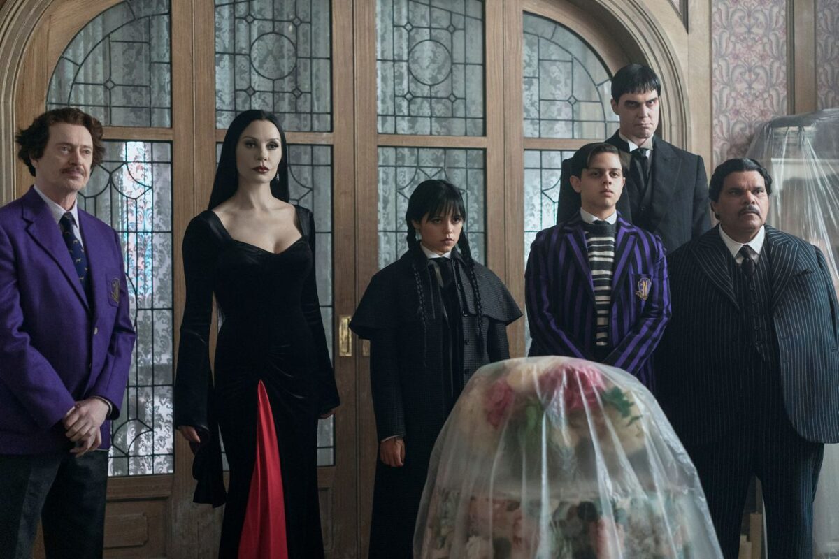 Steve Buscemi as Barry Dort, Catherine Zeta-Jones as Morticia Addams, Jenna Ortega as Wednesday Addams, Isaac Ordonez as Pugsley Addams, Joonas Suotamo as Lurch, Luis Guzmán as Gomez Addams in episode 201 of Wednesday.